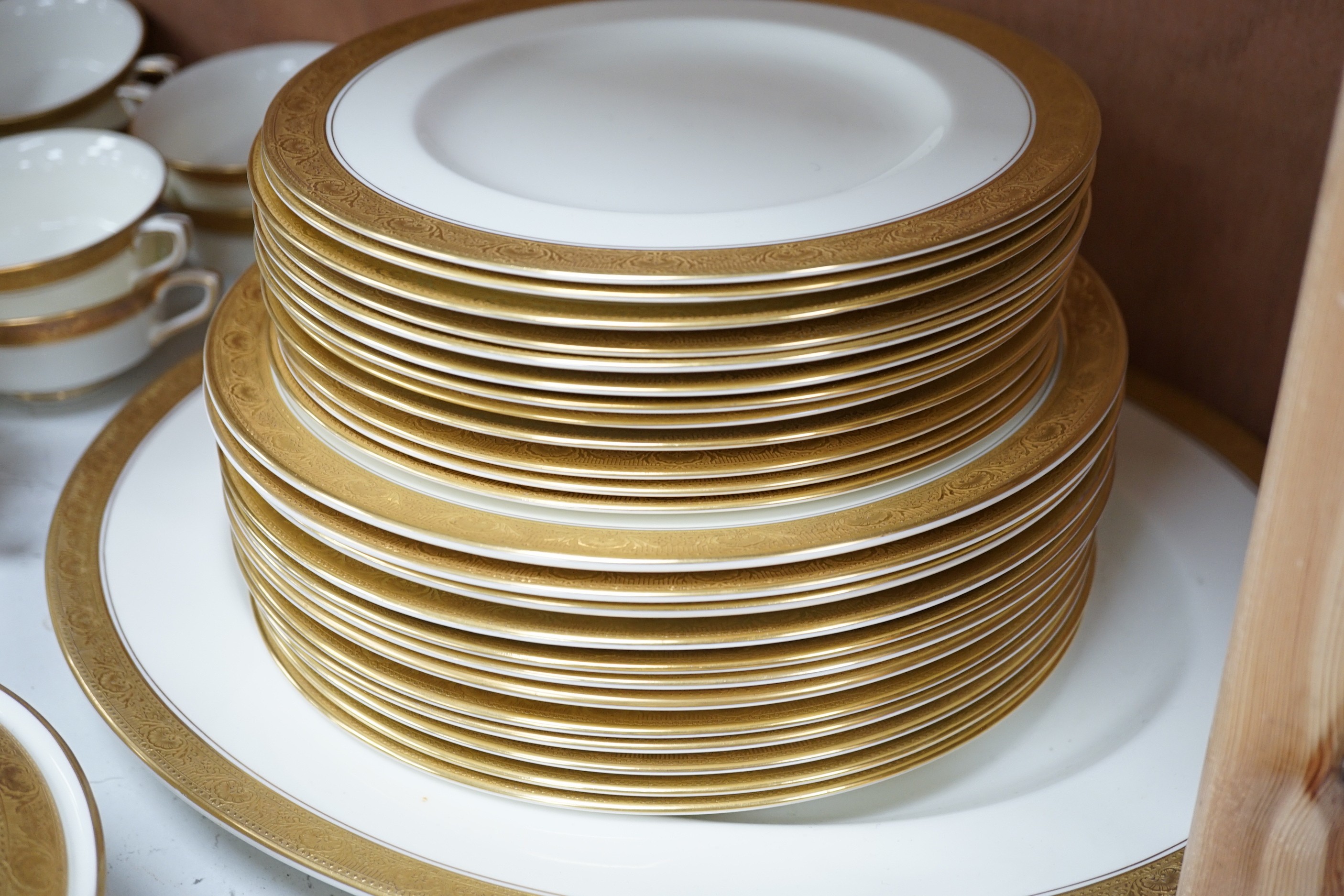 A Royal Worcester gilt edged part dinner service